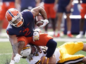 Wyoming nose tackle Cole Godbout tackles Illinois running back Chase Brown during the first half of an NCAA college football game, Saturday, Aug. 27, 2022, in Champaign, Ill. Brown showed why he was on the 2023 Senior Bowl watch list running for 151 yards and three touchdowns on 19 carries.