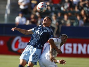 For a change of pace, Jake Nerwinski wants the Vancouver Whitecaps to land the first blow when they face the Los Angeles Galaxy in a Major League Soccer road game Saturday night. Vancouver Whitecaps defender Nerwinski (28) and LA Galaxy defender Julian Araujo (2) fight for a head ball in the first half of an MLS soccer match in Carson, Calif., Sunday, Aug. 8, 2021.