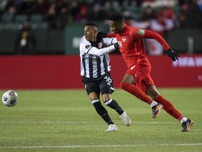 Pressure is building on Canada Soccer to seal a compensation deal with the men's national team as the countdown to the World Cup in Qatar ticks down. But some part of the negotiations could go beyond the November start of the tournament says Mark-Anthony Kaye, part of the men's national team leadership group. Kaye (14) and Costa Rica's Youstin Delfin Salas Gomez (16) vie for the ball during second half World Cup qualifier soccer action in Edmonton on Friday, November 12, 2021.