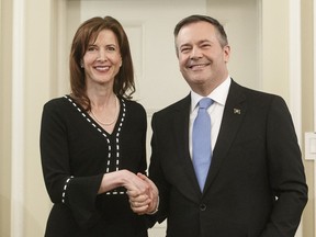 Premier Jason Kenney says Tanya Fir will become the minister for jobs, economy and innovation and continue to serve as the associate minister of red tape reduction. Kenney shakes hands with Fir at a cabinet swearin-in Edmonton on Tuesday April 30, 2019.