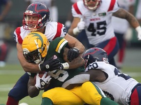 The Montreal Alouettes say player Christophe Normand has been suspended pending the outcome of a luring investigation. Normand (38) and Jeshrun Antwi (20) tackle Edmonton Elks' Terry Williams (5) during CFL action in Edmonton, Alta., on Saturday August 14, 2021.