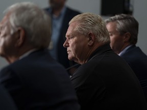 Ontario Premier Doug Ford, centre, attends a press conference with New Brunswick Premier Blaine Higgs, left, and Nova Scotia Premier Tim Houston following a meeting with the Maritime premiers in Moncton, N.B., on Monday, Aug. 22, 2022.