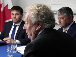 Conservative leadership candidates Roman Baber, left, Jean Charest, centre, and Scott Aitchison during the final official leadership debate, in Ottawa on Aug. 3, 2022.