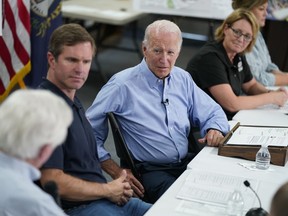 President Joe Biden participates in a briefing at Marie Roberts Elementary School about the ongoing response efforts to devastating flooding, Monday, Aug. 8, 2022, in Lost Creek, Ky. From left are Rep. Hal Rogers, R-Ky., Kentucky Gov. Andy Beshear, Biden, FEMA Administrator Deanne Criswell and Kentucky Lt. Gov. Jacqueline Coleman.
