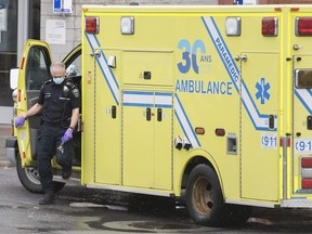 A health-care worker steps out of an ambulance at a hospital in Montreal, Friday, April 10, 2020.