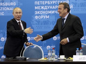 FILE -- Russian President Vladimir Putin, left, and Germany's former Chancellor Gerhard Schroeder attend an economic forum in St.Petersburg, Russia, Thursday, June 21, 2012. Former German leader Gerhard Schroeder is suing to restore the perks he enjoyed as ex-chancellor after he was stripped of them by parliament following criticism over his ties with Russia.