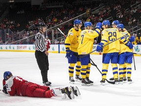 Sweden celebrates a goal against Czechia as Adam Mechura (11) lays on the ice during second period IIHF World Junior Hockey Championship bronze medal game action in Edmonton on Saturday August 20, 2022.