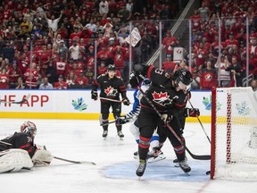 Canada's Mason McTavish (23) saves the puck from going into the net on a shot from Finland during overtime IIHF World Junior Hockey Championship gold medal game action in Edmonton on Saturday August 20, 2022.