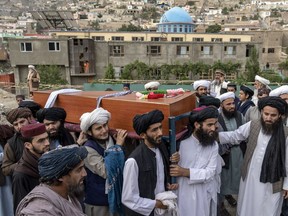 Mourners carry the body of a victim of a mosque bombing in Kabul, Afghanistan, Thursday, Aug. 18. 2022. A bombing at a mosque in Kabul during evening prayers on Wednesday killed at least 10 people, including a prominent cleric, and wounded over two dozen, an eyewitness and police said.