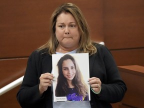 Jennifer Montalto holds a picture of her daughter, Gina, before giving her victim impact statement during the penalty phase of the trial of Marjory Stoneman Douglas High School shooter Nikolas Cruz at the Broward County Courthouse in Fort Lauderdale, Fla., Wednesday, Aug. 3, 2022. Gina Montalto was killed in the 2018 shootings. Cruz previously plead guilty to all 17 counts of premeditated murder and 17 counts of attempted murder in the 2018 shootings.