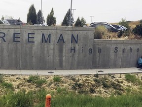 FILE - The sign for Freeman High School in Rockford, Wash., is seen outside the campus on Sept. 13, 2017. A man who shot one classmate to death and wounded three others five years ago in a Washington state high school, apologized to his victims before he was sentenced to 40 years in prison Friday, Aug. 19, 2022. Caleb Sharpe, who was 15 at the time of the 2017 shootings at Freeman High School, pleaded guilty earlier this year in Spokane County Superior Court.