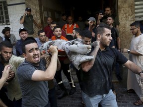 EDS NOTE: GRAPHIC CONTENT - Mourners carry the body of Taiseer al-Jabari, Islamic Jihad commander, who was killed during Israeli airstrikes on his apartment in Gaza City, Friday, Aug. 5, 2022. Palestinian officials say Israeli airstrikes on Gaza have killed several people, including a senior militant, and wounded 40 others.