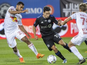 CF Montreal's Joaquin Torres, centre, breaks away New York Red Bulls' Cristian Casseres Jr. (23) and Daniel Edelman during first half MLS soccer action in Montreal on Wednesday, August 31, 2022.