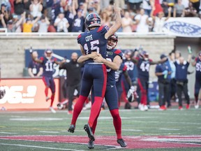 Montreal Alouettes kicker David Cote (15) is hoisted in the air by teammate Joseph Zema after scoring the winning field goal against the Hamilton Tiger-Cats during second half CFL football action in Montreal, Saturday, August 20, 2022.