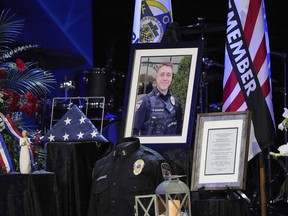 Pictures and mementos are displayed at the funeral for 24-year-old Elwood Police Officer Noah Shahnavaz at ITOWN Church, on Saturday, Aug. 6, 2022, in Fishers, Ind. Shahnavaz was fatally shot while making a traffic stop in Madison County on July 31.