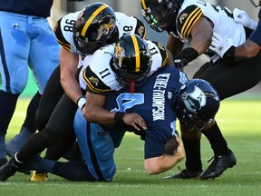 Toronto Argonauts' quarterback McLeod Bethel-Thompson (4) is sacked by Hamilton Tiger-Cats defensive back Kameron Kelly (11) during first half CFL football action in Toronto on Saturday, August 6, 2022.