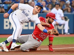 Los Angeles Angels' second baseman David Fletcher (22) slides safely into third base ahead of a tag by Toronto Blue Jays' third baseman Matt Chapman in first inning American League baseball action in Toronto on Friday, August 26, 2022.