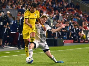Toronto FC forward Jacob Shaffelburg gets the ball away from Columbus Crew forward Miguel Berry during second half MLS soccer action in Toronto on June 29, 2022. Toronto FC has loaned Shaffelburg to Nashville SC for the rest of the 2022 season.