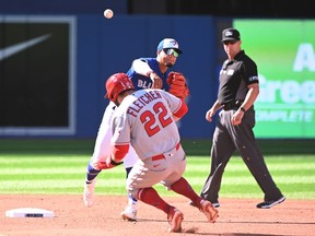 Toronto Blue Jays second baseman Santiago Espinal throws to first base to complete a double play on Los Angeles Angels Mike Trout after forcing David Fletcher (22) at second during third inning American League baseball action in Toronto on Saturday, August 27, 2022.