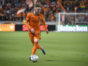 Houston Dynamo forward Tyler Pasher (19) drives the ball downfield against the Colorado Rapids during the second half of an MLS soccer match, Saturday, March 19, 2022, in Houston.