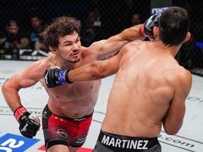 (The Canadian Gangster) Olivier Aubin-Mercier (in red trunks) throws a punch in his PFL lightweight semifinal win over Paraguay's Alex Martinez in New York on Friday, August 5, 2022. Aubin-Mercier won a unanimous decision and is now one win from the PFL title and a US$1-million payday.