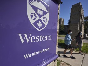Students walk across campus at Western University in London, Ont., September 19, 2020. Concerns are being raised that Western University's decision to mandate COVID-19 boosters shortly before the fall semester may create barriers for marginalized students. The London, Ont., university announced Monday that students and staff returning to campus must have at least three COVID-19 shots and wear masks in classrooms. Ethan Gardner, president of the university's student council, says the tight timeline for the policy change is the most common concern he's hearing so far. Infectious diseases specialist Dr. Zain Chagla says the purpose of Western's three-dose policy is unclear.