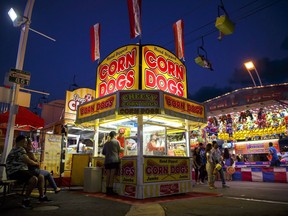 A corn dog vendor is seen at the 140th annual Canadian National Exhibition in Toronto on Sunday, August 19, 2018. The Canadian National Exhibition is set to return Friday as Technical Standards and Safety Authority (TSSA) workers remain on strike, causing concern over how the strike could impact the fair's return.