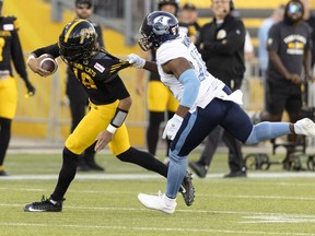 Hamilton Tiger-Cats quarterback Matt Shiltz (18) is tackled by Toronto Argonauts linebacker Henoc Muamba (10) during first half CFL football game action in Hamilton, Ont. on August 12, 2022. Following a one-week hiatus, Muamba and the Toronto Argonauts will again square off against their arch rivals. Toronto (4-5) hosts the Hamilton Tiger-Cats (3-7) at BMO Field on Friday night before the two teams meet again at Tim Hortons Field on Sept. 5 in their annual Labour Day showdown. The Argos and Ticats opened a two-game series three weeks ago, with the home team winning each contest.