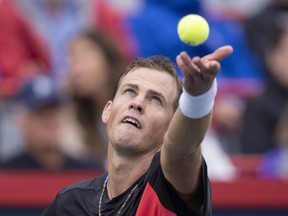 Canada's Vasek Pospisil serves to Tommy Paul of the United States during first round action at the National Bank Open tennis tournament in Montreal on August 9, 2022.