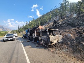 A burned out vehicle is shown after an accident sparked a wildfire on Highway 3 west of Osoyoos near Richter Mountain in this recent handout photo. Residents near the blaze have been told they may have to leave at a moment's notice.