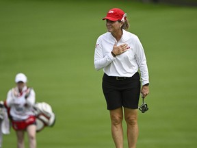 Canada's Lorie Kane puts her hand on her chest as she is applauded by fans, as her niece and caddy Charlotte Jenkins walks behind her on the green at the 18th hole during the CP Women's Open in Ottawa on Friday, Aug. 26, 2022.