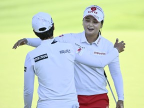 South Korea's Hye-Jin Choi embraces fellow South Korean Na Rin An, left,&ampnbsp;are co-leaders after three rounds at the CP Women's Open in Ottawa on Saturday, Aug. 27, 2022.