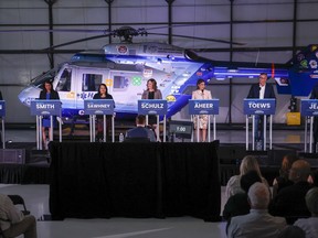 Candidates, left to right, Todd Loewen, Danielle Smith, Rajan Sawhney, Rebecca Schulz, Leela Aheer, Travis Toews, and Brian Jean, attend the United Conservative Party of Alberta leadership candidate's debate in Medicine Hat, Alta., on July 27, 2022. The party is set to hold its final leadership debate tonight as the campaign to replace Premier Jason Kenney moves into the homestretch.