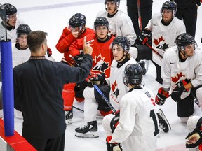 Canada's National Junior Team assistant coach Michael Dyck, left, gives instructions during a training camp practice in Calgary, Tuesday, Aug. 2, 2022.THE CANADIAN PRESS/Jeff McIntosh