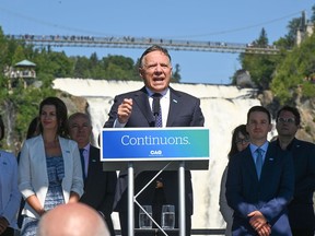 Coalition Avenir Québec Leader François Legault, centre, launches his campaign at the Montmorency Falls with candidates, Sunday, Aug. 28, 2022, in Quebec City. Legault is campaigning today in the electoral district of Iberville -- a riding the party won in 2018 but then lost after its member joined the Conservatives.