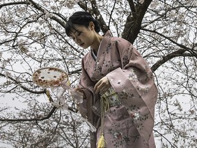 A women wearing a kimono poses for photos in Wuhan, China. Wearing a kimono has become increasingly controversial in China as the nationalist sentiment rises under President Xi Jinping's rule.