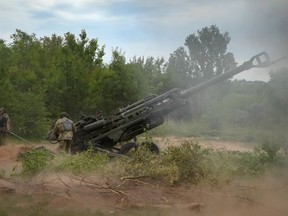 FILE - Ukrainian soldiers fire at Russian positions from a U.S.-supplied M777 howitzer in Ukraine's eastern Donetsk region, June 18, 2022. The deliveries of Western weapons have been crucial for Ukraine's efforts to fend off Russian attacks in the country's eastern industrial heartland of Donbas. The Western howitzers have some advantages compared to older Soviet-designed systems in the Russian and Ukrainian arsenals, but they require time for the Ukrainian crews to train how to operate them and their wide assortment poses obvious logistical challenges.