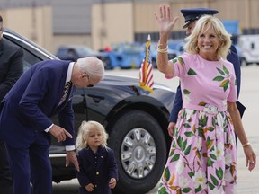 FILE - President Joe Biden looks at his grandson Beau Biden as first lady Jill Biden waves and walks to board Air Force One at Andrews Air Force Base, Md., Aug. 10, 2022. First lady Jill Biden tested positive for COVID-19 and is experiencing 'mild symptoms' the White House announced Tuesday.
