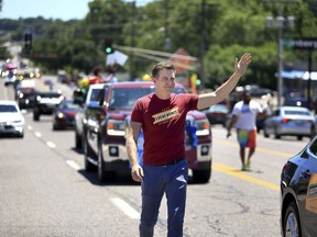 Lucas Kunce, a candidate who is seeking the Democratic nomination for the U.S. Senate, waves to people along West Florissant Ave. during the Dellwood Juneteenth Parade and Celebration on Sunday, June 19, 2022, in Dellwood, Mo. Kunce brings a Marine swagger and a grassroots populism that appeals to some, particularly in outstate Missouri. He has raised more money than any other candidate -- Democrat or Republican -- in each of the last four quarters.