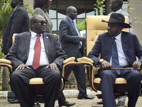 FILE - South Sudan's then First Vice President Riek Machar, left, looks across at President Salva Kiir, right, as they sit to be photographed following the first meeting of a transitional coalition government, in the capital Juba, South Sudan on April 29, 2016. Parties to the peace deal ending South Sudan's devastating civil war on Thursday, Aug. 4, 2022 again delayed the country's first elections since independence by extending the transitional period by two years.