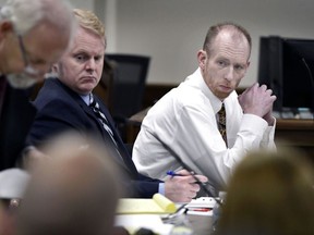 FILE - Chad Isaak, right, of Washburn, sits with his defense team during the third day of his murder trial at the Morton County Courthouse in Mandan, N.D., on Wednesday, Aug. 4, 2021. Authorities say Isaak, convicted in a 2019 quadruple slaying, has killed himself in prison. Isaak was appealing his convictions in the killings of the owner of a Mandan property management business and three workers there.