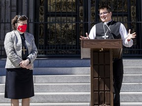 FILE - Bishop Elizabeth Eaton, left, listens as Bishop Megan Rohrer speaks to the media before their installation ceremony at Grace Cathedral in San Francisco, Saturday, Sept. 11, 2021. Rohrer is the first openly transgender person elected as bishop in the Evangelical Lutheran Church of America. Eaton, presiding bishop of the Evangelical Lutheran Church in America, issued a public apology Tuesday, Aug. 9, 2022, to members of a majority Latino immigrant congregation for the pain and trauma caused after Rohrer unexpectedly fired their pastor.