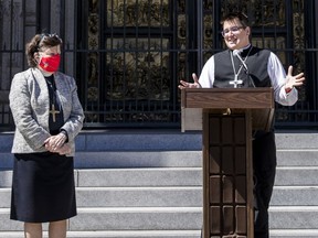 FILE - Bishop Elizabeth Eaton, left, listens as Bishop Megan Rohrer speaks to the media before their installation ceremony at Grace Cathedral in San Francisco, Saturday, Sept. 11, 2021. Rohrer is the first openly transgender person elected as bishop in the Evangelical Lutheran Church of America. Eaton, presiding bishop of the Evangelical Lutheran Church in America, issued a public apology Tuesday, Aug. 9, 2022, to members of a majority Latino immigrant congregation for the pain and trauma caused after Rohrer unexpectedly fired their pastor.