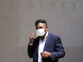 FILE - Former NFL player Ken Jenkins exits the building after delivering tens of thousands of petitions demanding equal treatment for everyone involved in the settlement of concussion claims against the NFL, to the federal courthouse in Philadelphia, on May 14, 2021. Hundreds of Black NFL retirees denied payouts in the $1 billion concussion settlement now qualify for awards after their tests were rescored to eliminate racial bias, according to a report released Friday, Aug, 12, 2022.