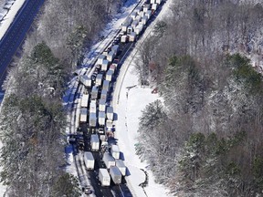 FILE - Drivers wait for the traffic to be cleared as cars and trucks are stranded on sections of Interstate 95 on Jan. 4, 2022, in Carmel Church, Va. The state government failed to carry out numerous lessons from a 2018 snowstorm that caused highway gridlock, as exhibited by a similar event along Interstate 95 in January that left hundreds of motorists stranded, according to a report from Virginia's Office of the Inspector General on Friday, Aug. 12, 2022.