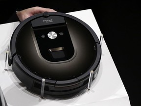 FILE - A Roomba 980 vacuum cleaning robot is presented during a presentation in Tokyo, Tuesday, Sept. 29, 2015. Amazon on Friday, Aug. 5, 2022, announced it has entered into an agreement to acquire the vacuum cleaner maker iRobot for approximately $1.66 billion. The company sells its robots worldwide and is most famous for the circular-shaped Roomba vacuum.