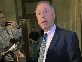 FILE - Wisconsin Assembly Speaker Robin Vos talks to reporters March 16, 2022, in Madison, Wis. Vos defeated a little-known Donald Trump-endorsed challenger in the Republican primary Tuesday, Aug. 8, overcoming intense criticism from Trump and others that he hadn't pursued decertifying the 2020 election won by President Joe Biden.