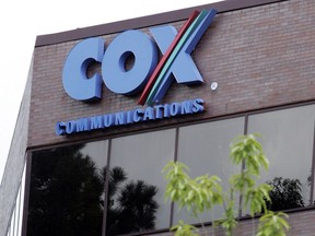 One of the buildings of the Cox Communications campus is surrounded by foliage in Atlanta on, Aug. 2, 2004. Cox Enterprises, which owns Cox Communications, is buying Axios Media for $525 million as it looks to grow and diversify its business. Cox, which became an investor in Axios last year, said Monday Aug. 8, 2022, that it will look to expand Axios into more cities, while having it cover more national topics and serve more premium niches for professionals.
