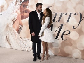 FILE - Cast member Jennifer Lopez, right, and Ben Affleck attend a photo call for a special screening of "Marry Me" at DGA Theater on Feb. 8, 2022, in Los Angeles. Lopez and Affleck said "I do" again this weekend. But instead of in a late night Las Vegas drive through chapel, this time it was in front of friends and family in Georgia, a person close to the couple who was not authorized to speak publicly said Sunday, Aug. 21, 2022.