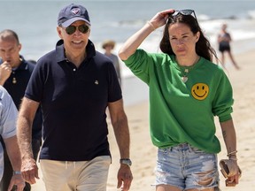 FILE -- President Joe Biden walks on the beach with daughter Ashley Biden, in Rehoboth Beach, Del., June 20, 2022. Two people have pleaded guilty in a scheme to peddle a diary and other items belonging to President Joe Biden's daughter Ashley to the conservative group Project Veritas, prosecutors said Thursday, Aug. 25, 2022.